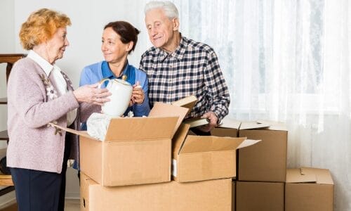 Seniors Unpacking After A Move With Their Child