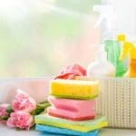 Various cleaning products and tools arranged on a clean surface, symbolizing the preparation needed for decluttering an Edmonton home for a move.
