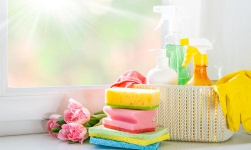 Various cleaning products and tools arranged on a clean surface, symbolizing the preparation needed for decluttering an Edmonton home for a move.